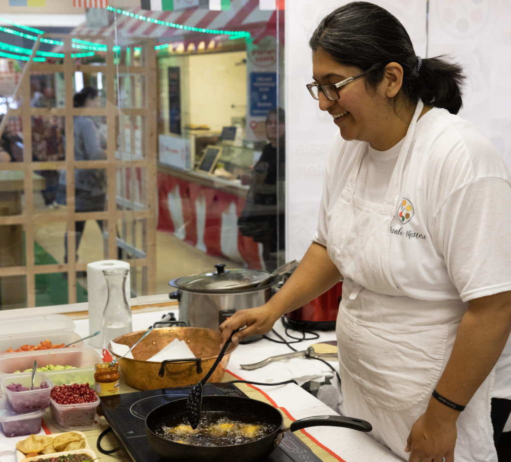 Woman cooking at Freeman Street Market Food Fight Event