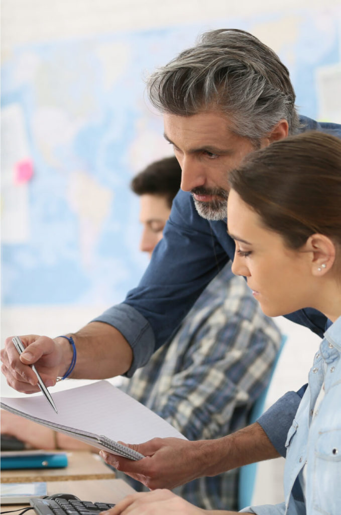 Man and woman looking at plans on a notebook