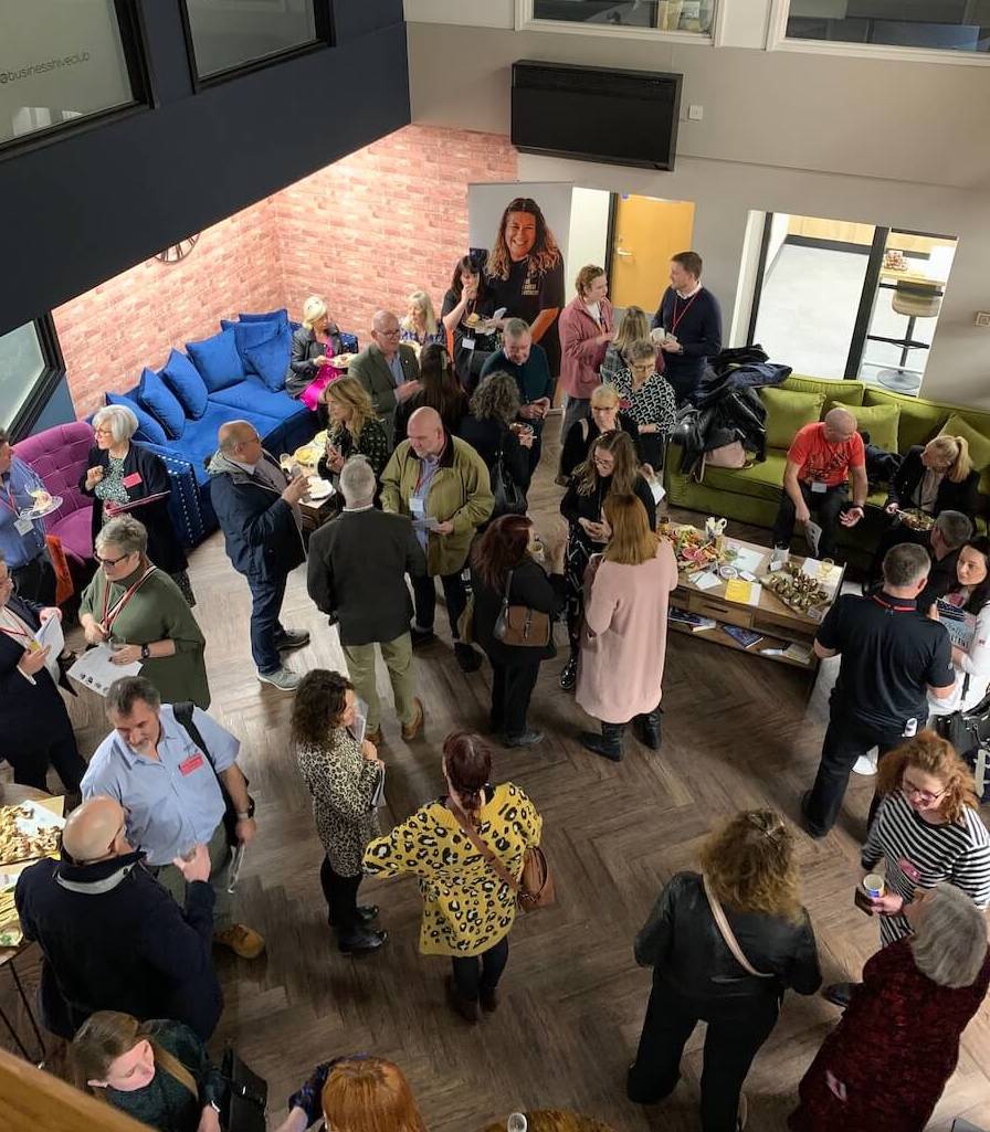 A group of business professionals gathered in a room at the Hive Club.